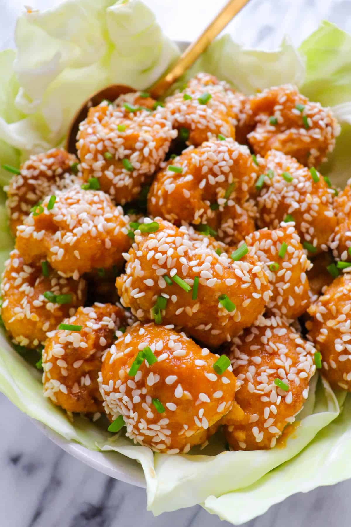 Close up shot of baked orange cauliflower wings.