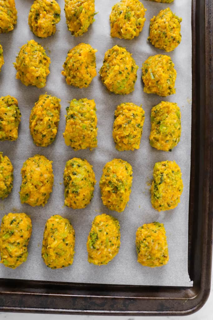 Unbaked tots on baking tray.