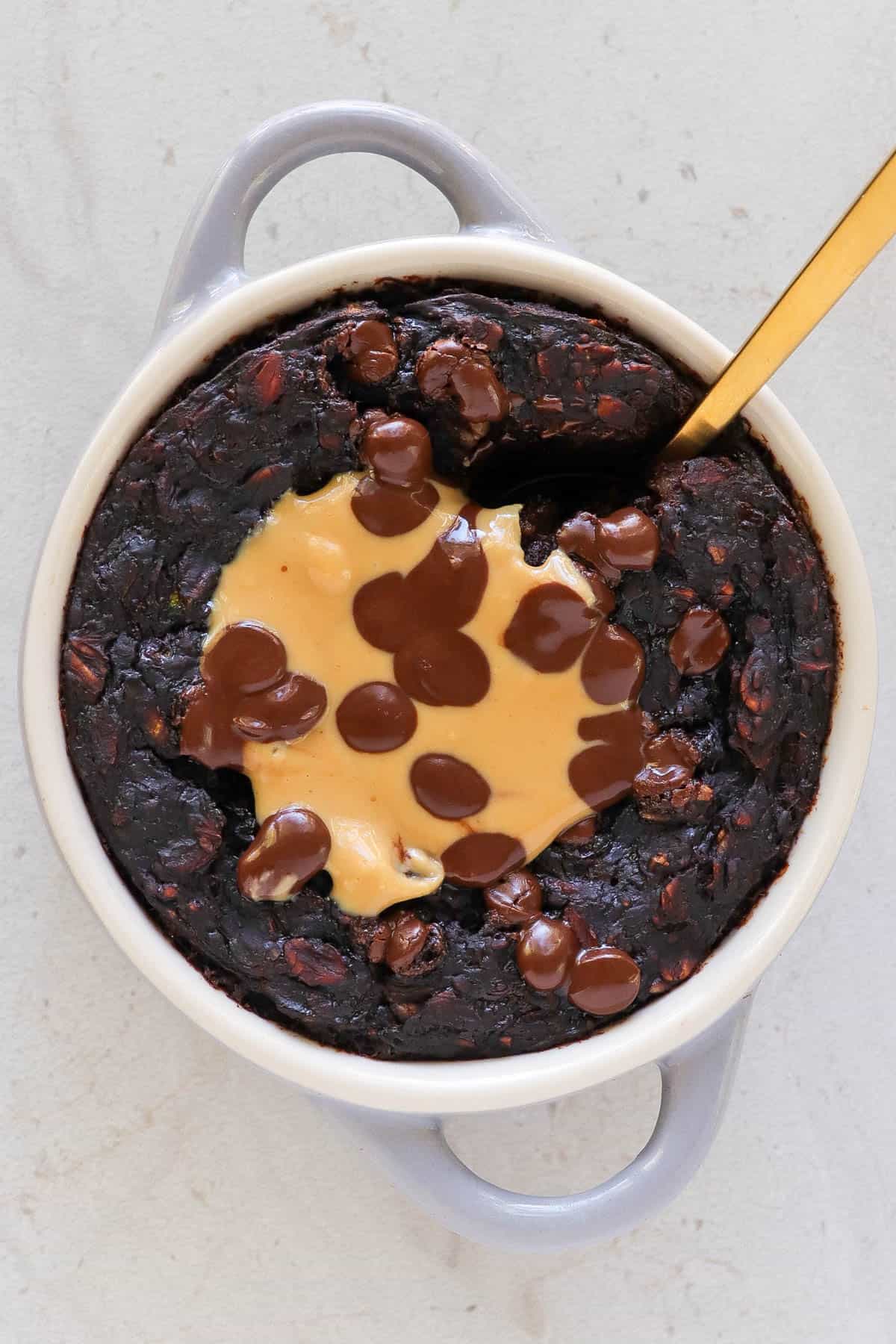 Baked oats with peanut butter and melted chocolate chips on top for decoration.