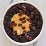 Baked chocolate oats with peanut butter and melted chocolate chips on top.