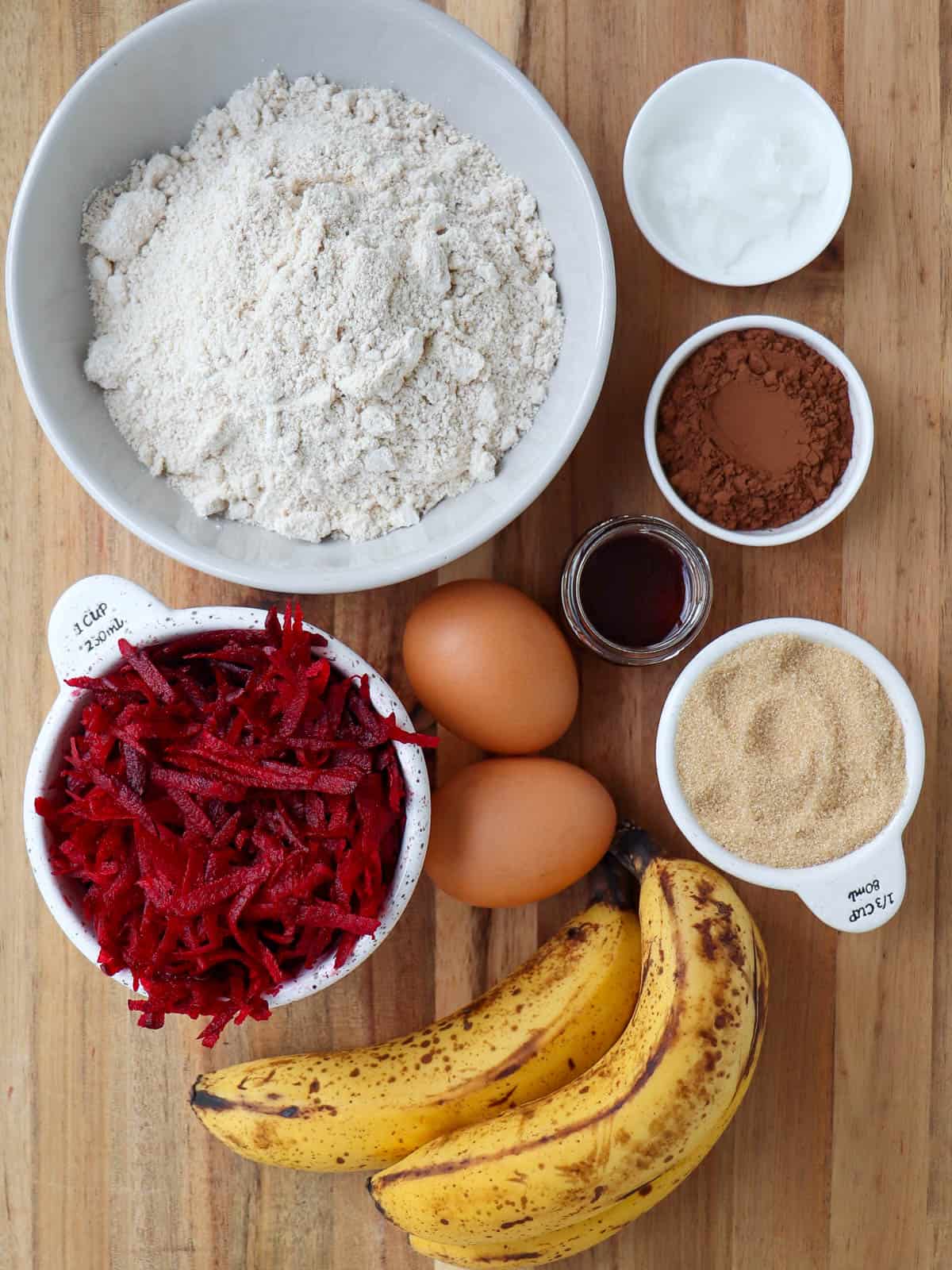 Red velvet cake ingredients on wooden board.