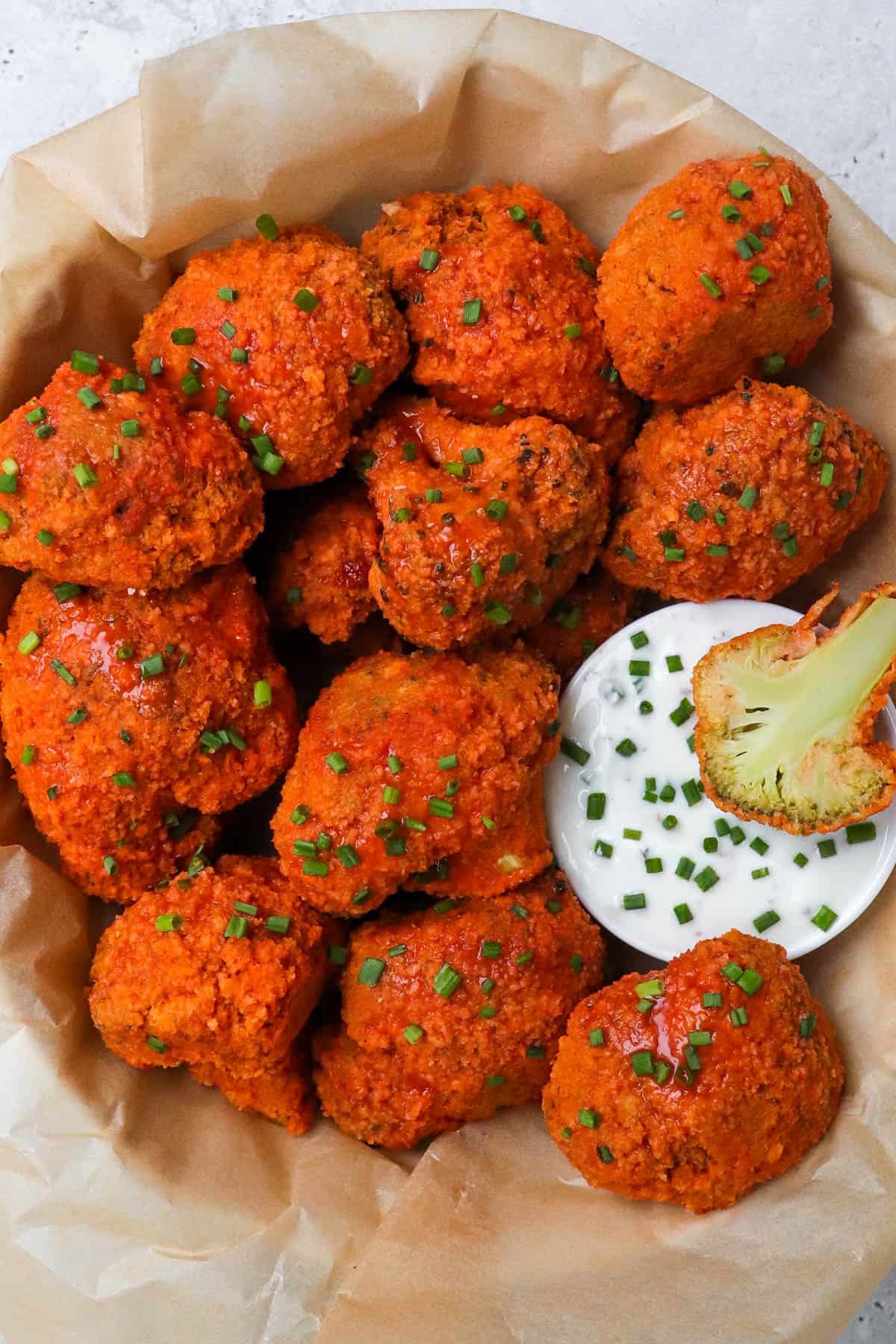 Buffalo broccoli wings in a bowl with ranch.