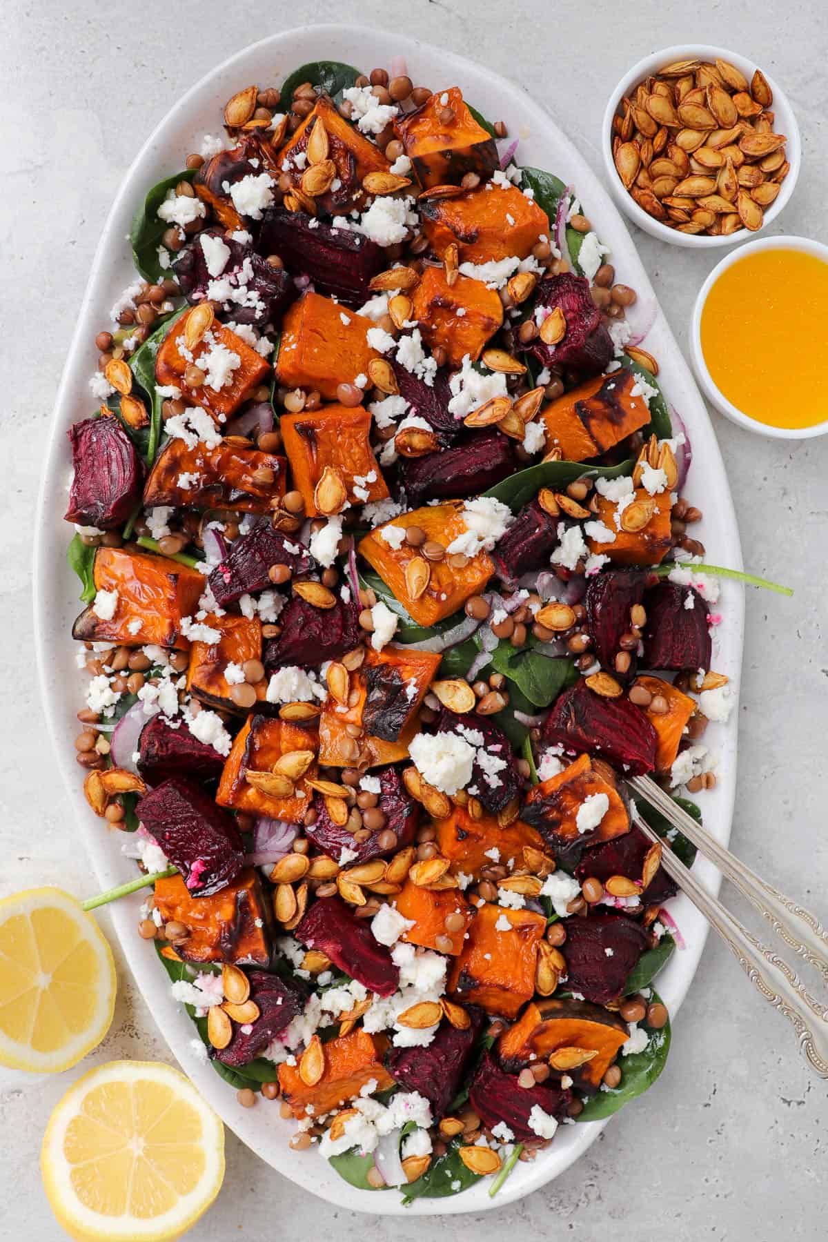 Salad on platter with serving forks.