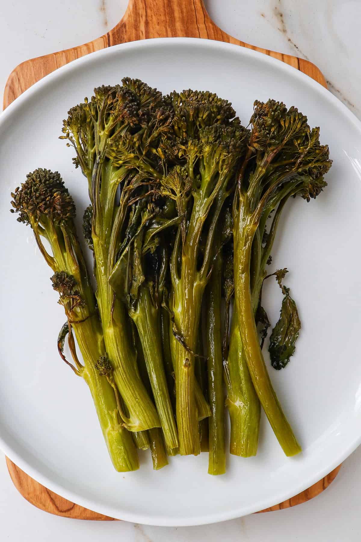 Roasted broccolini on plate.