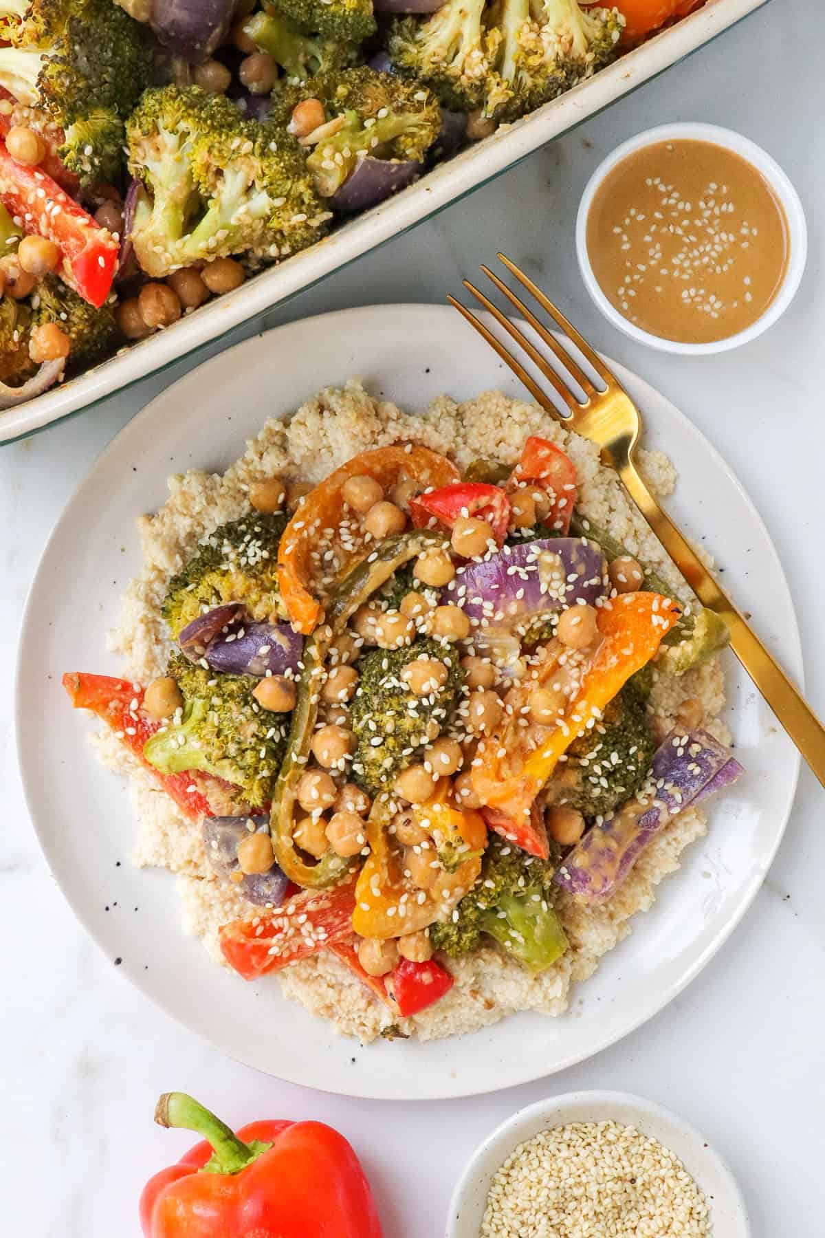 Chickpeas and veggies served with couscous on plate with fork.