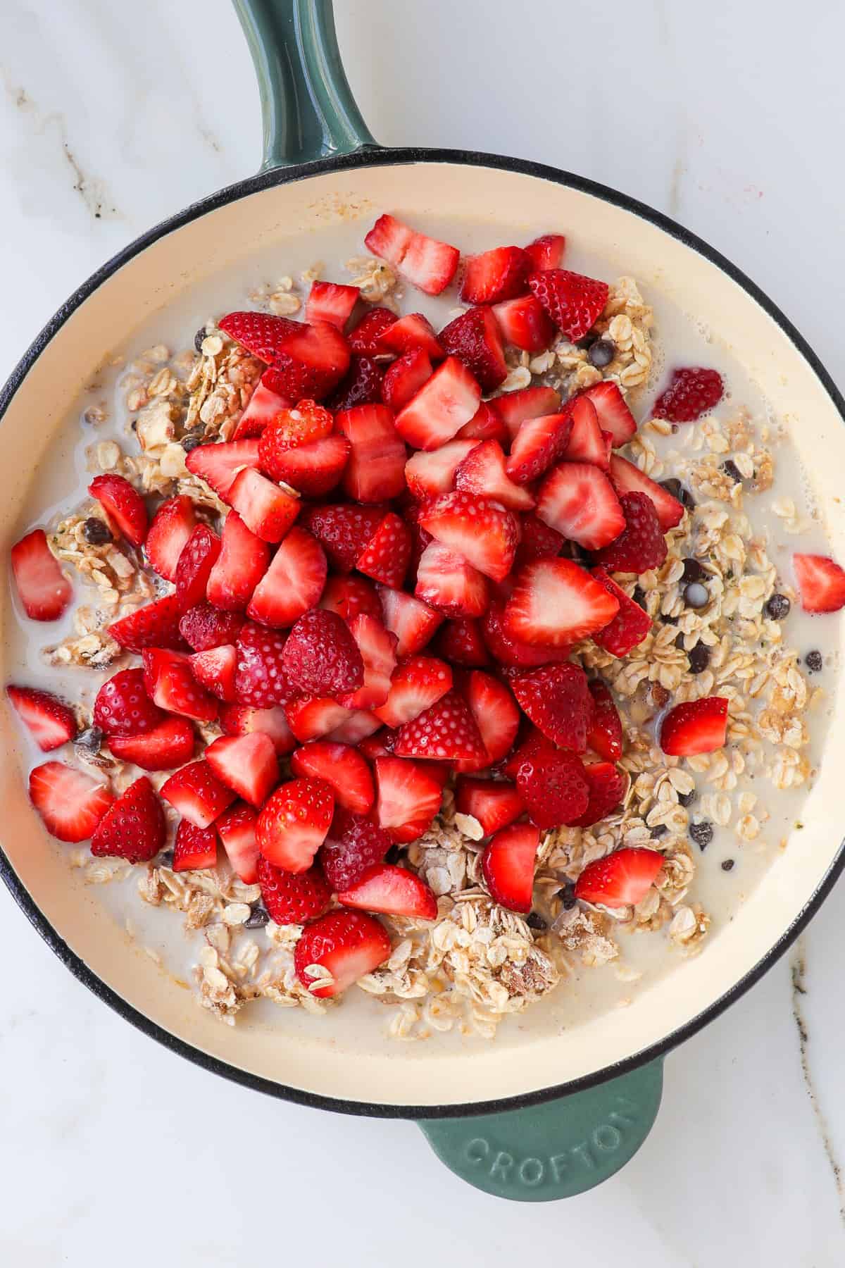 Strawberries and milk added to the pan with the dry ingredients.