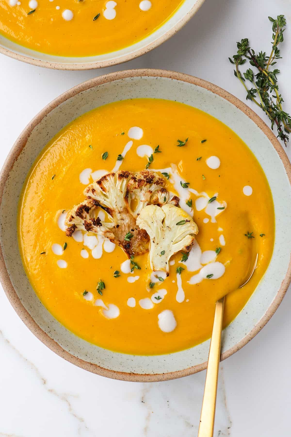 Pumpkin cauliflower soup in a bowl.