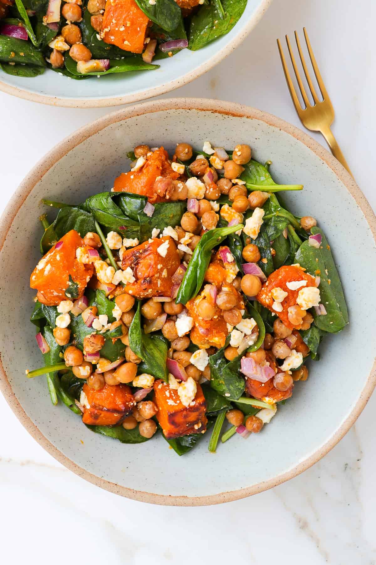 Salad in a bowl with fork on the side.