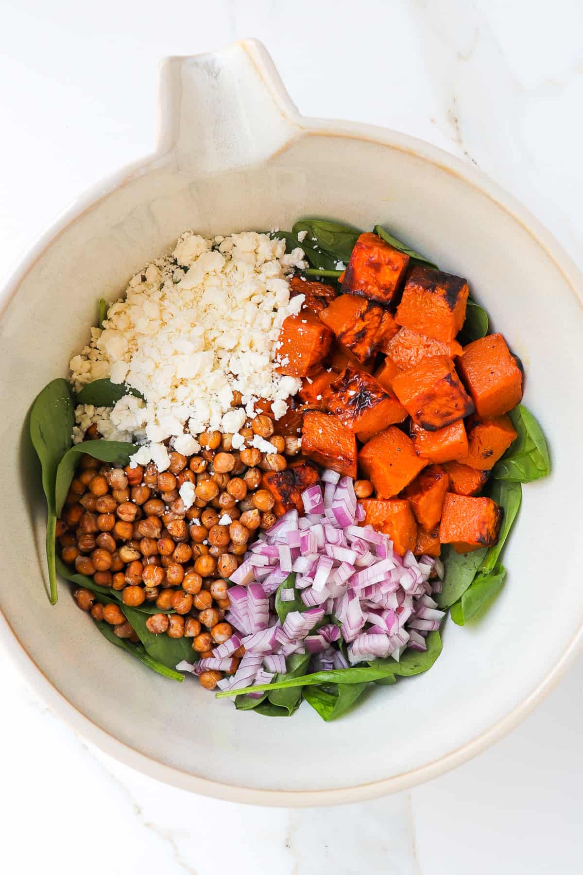 Salad ingredients in a bowl before being mixed.