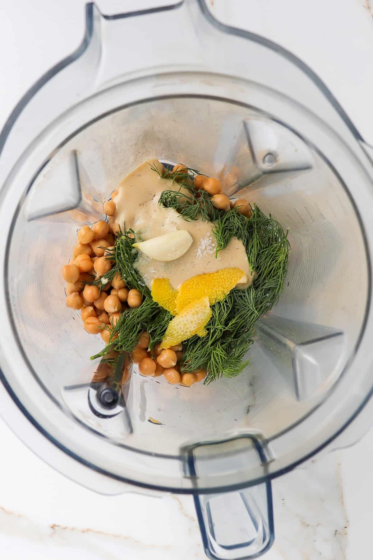 Ingredients to make hummus in a blender.