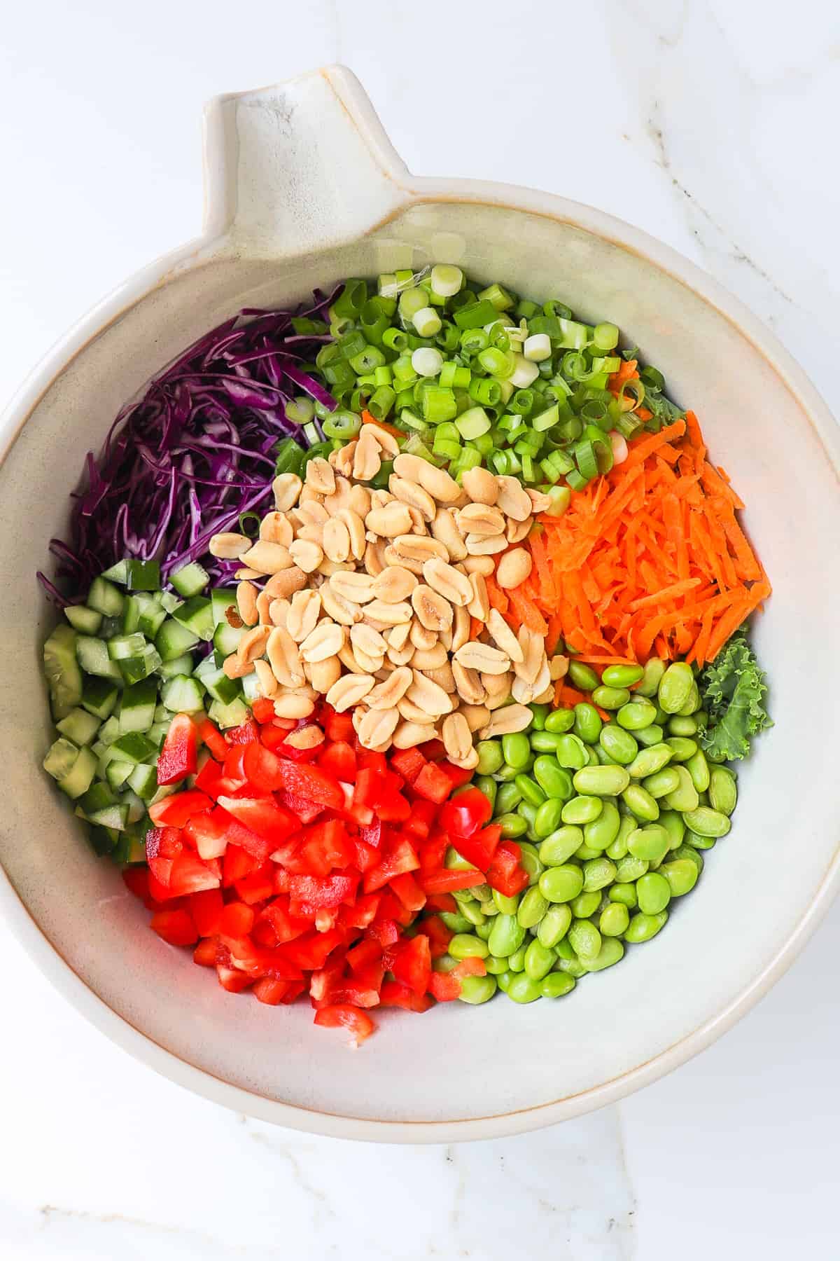 Edamame, peanuts and chopped veggies in a large mixing bowl.