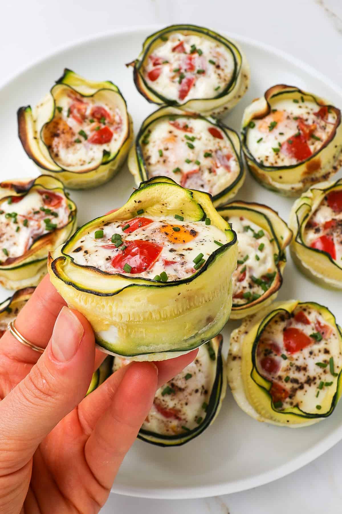 Close up shot of zucchini egg cup in hand.
