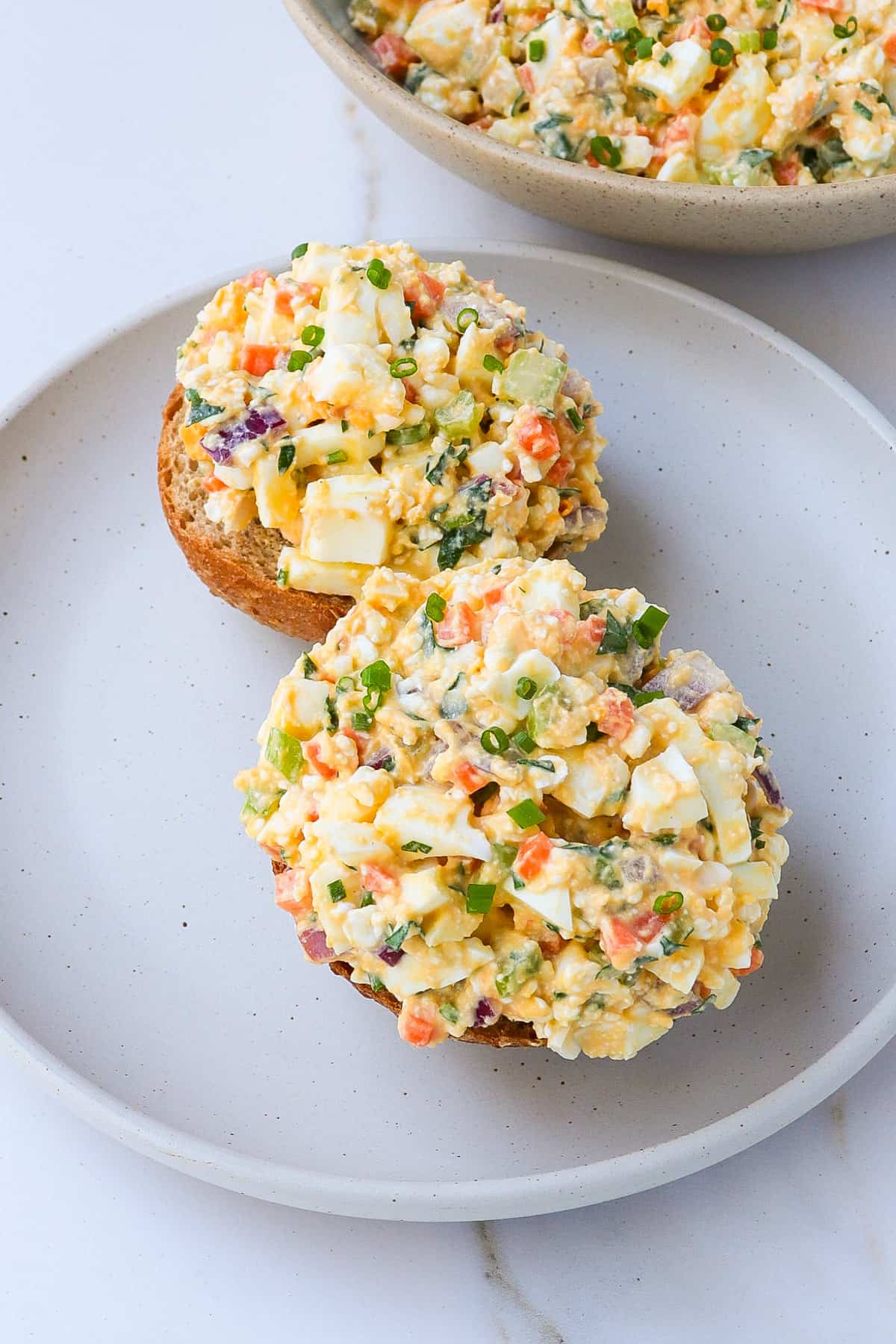 Egg salad with cottage cheese on bread rolls.
