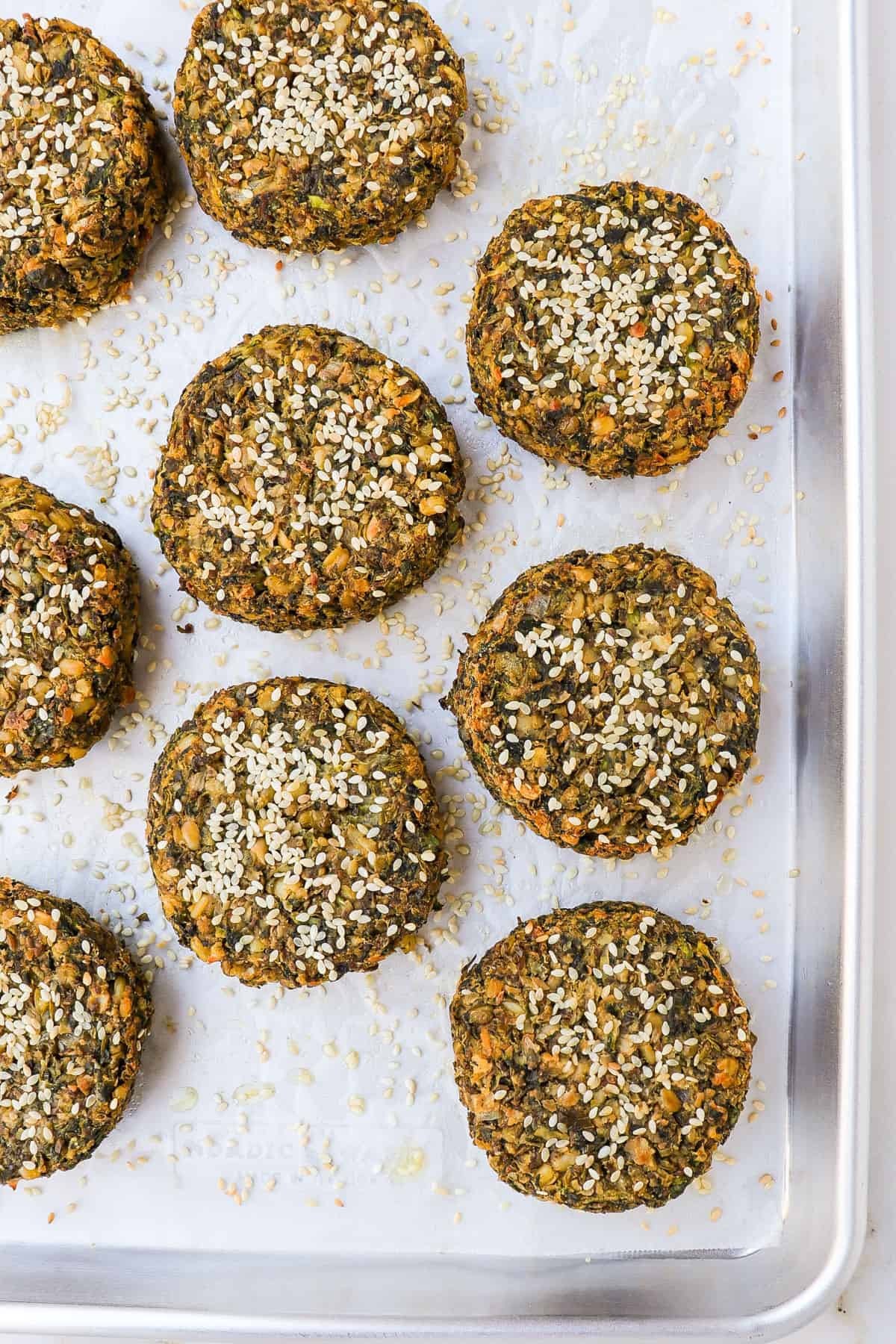 Baked mung bean burgers on a baking sheet.