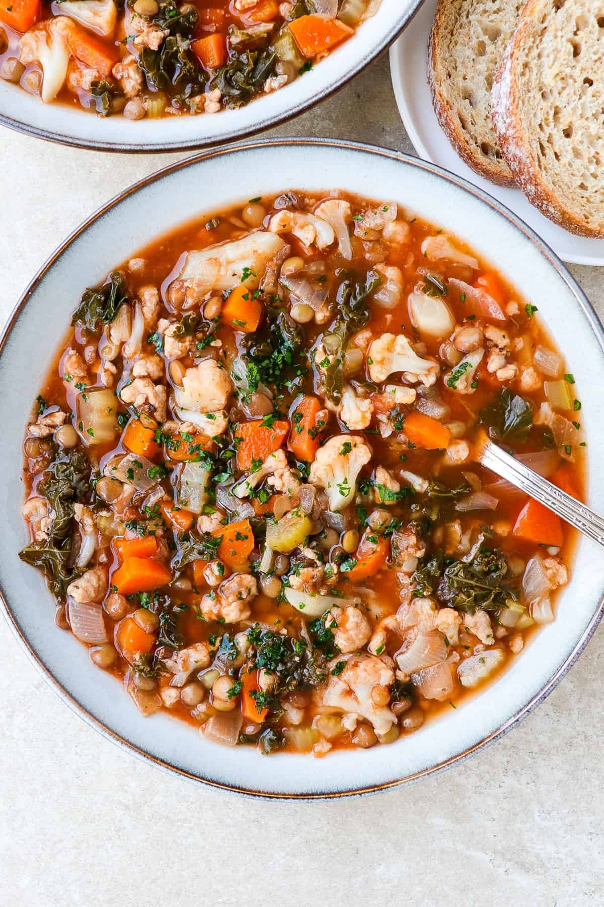 Turkey soup in a bowl with a spoon.