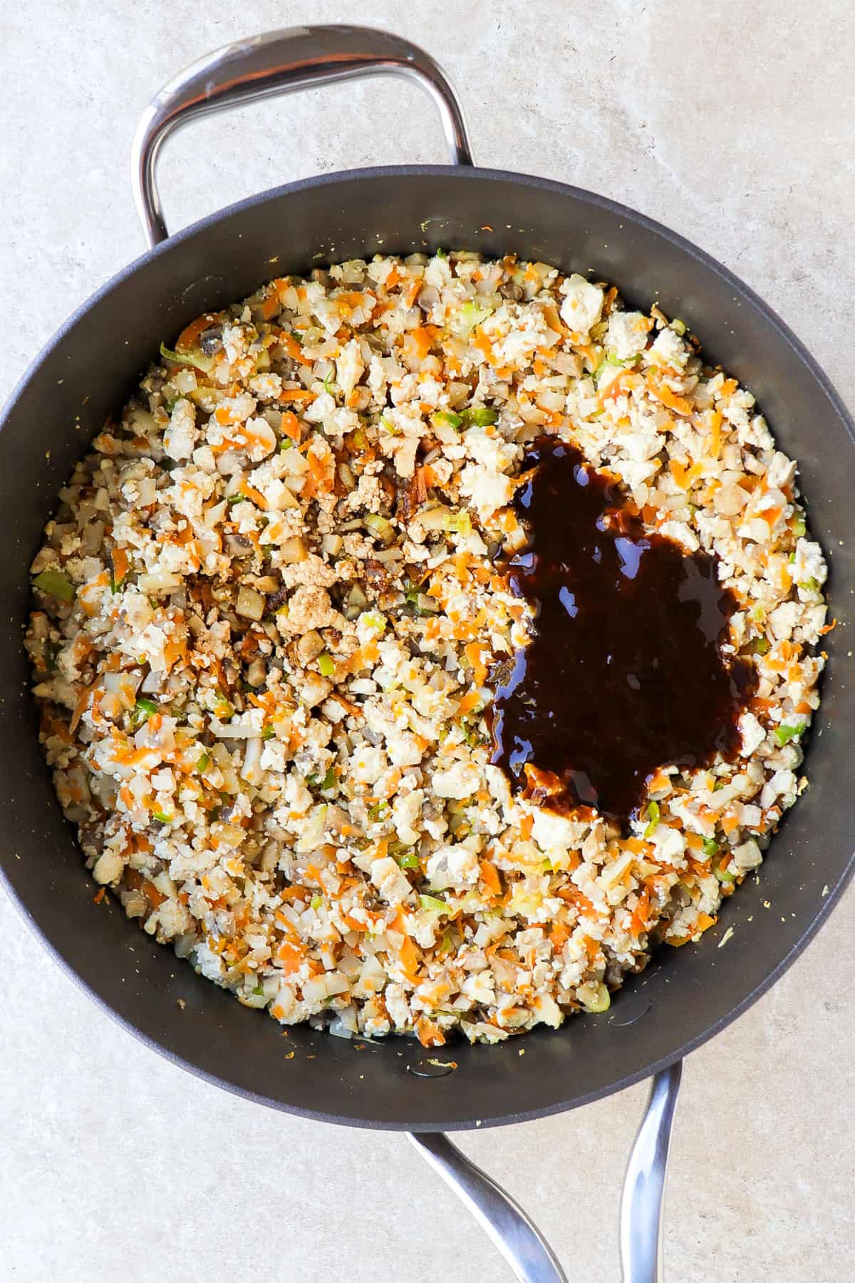 Tofu veggie filling in a pan with sauce.
