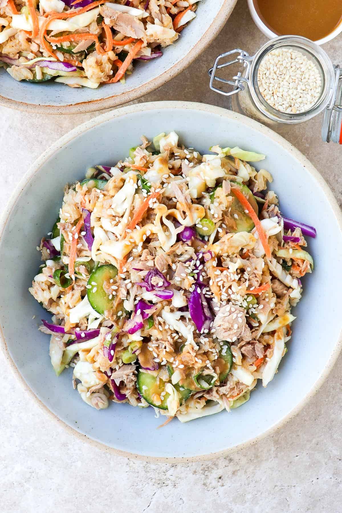 Side shot of tuna cabbage salad in a blue bowl.