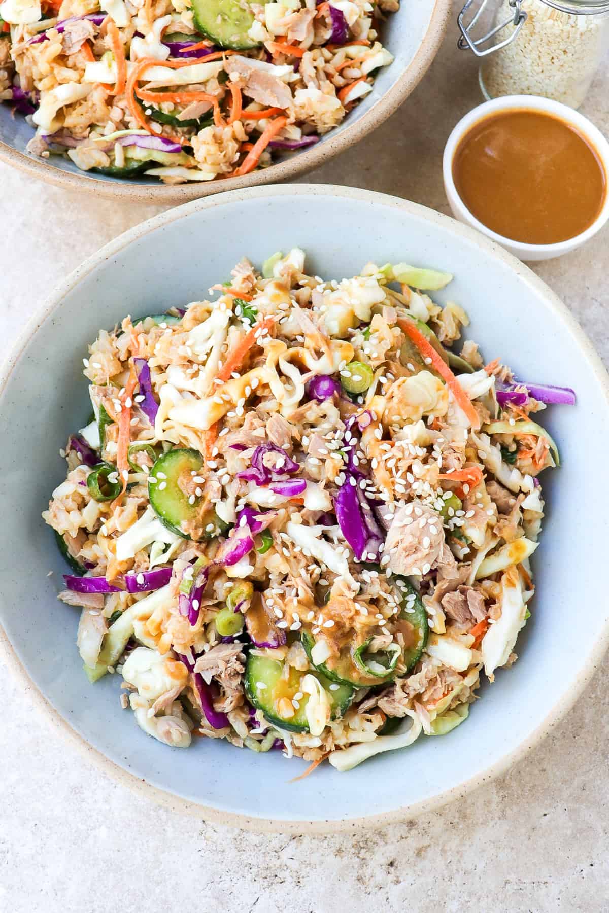 Side shot of tuna cabbage salad in a blue bowl.