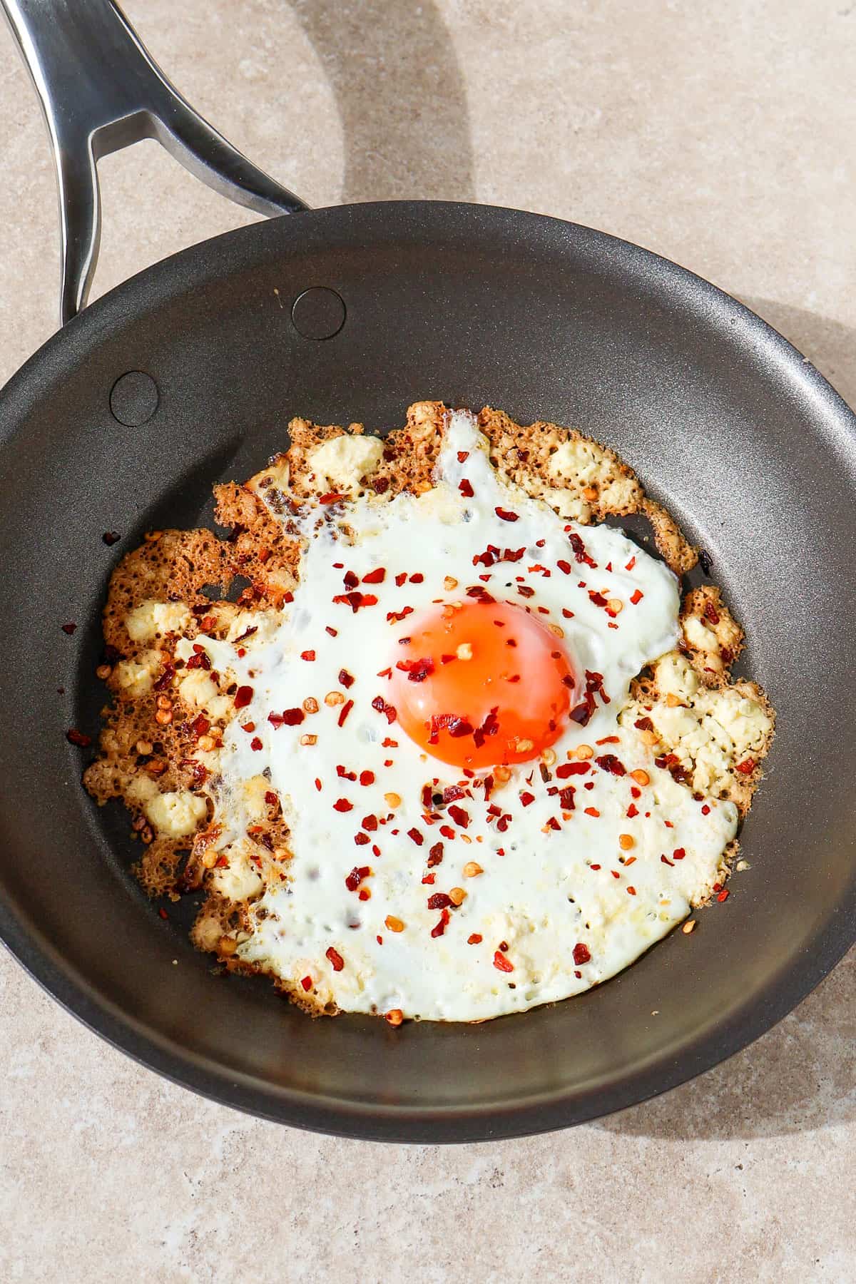 Crispy feta fried egg in a skillet.