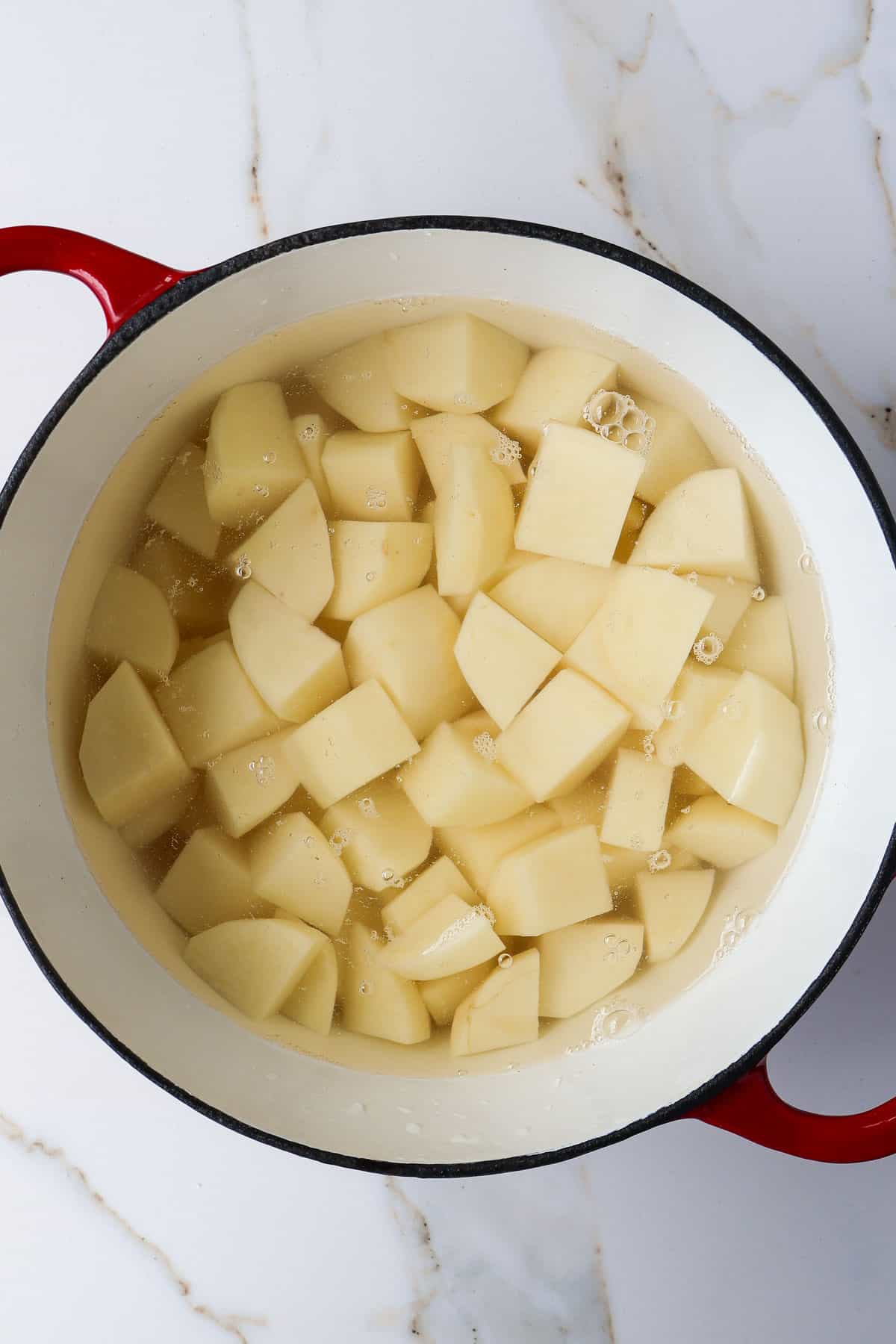 Potatoes in a pot of water.