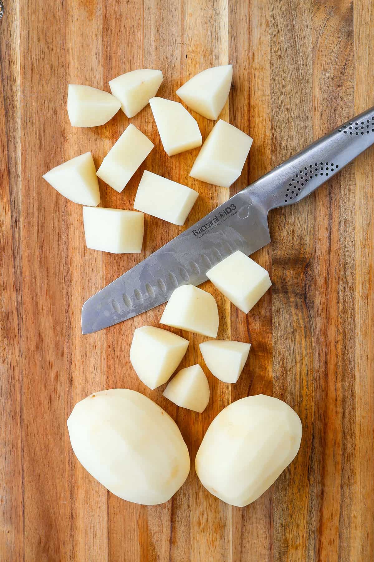 Chopped potatoes on a wooden board.