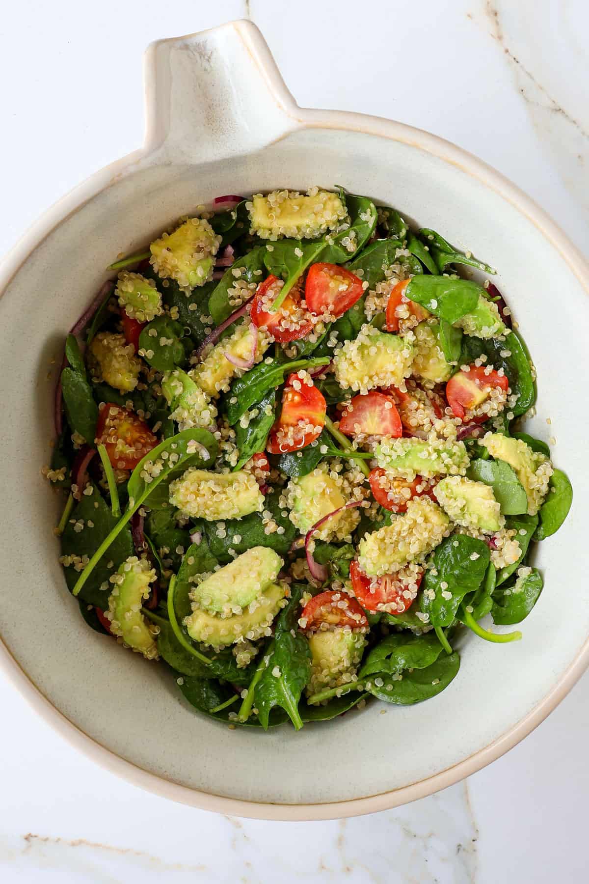Avocado quinoa salad in a mixing bowl.