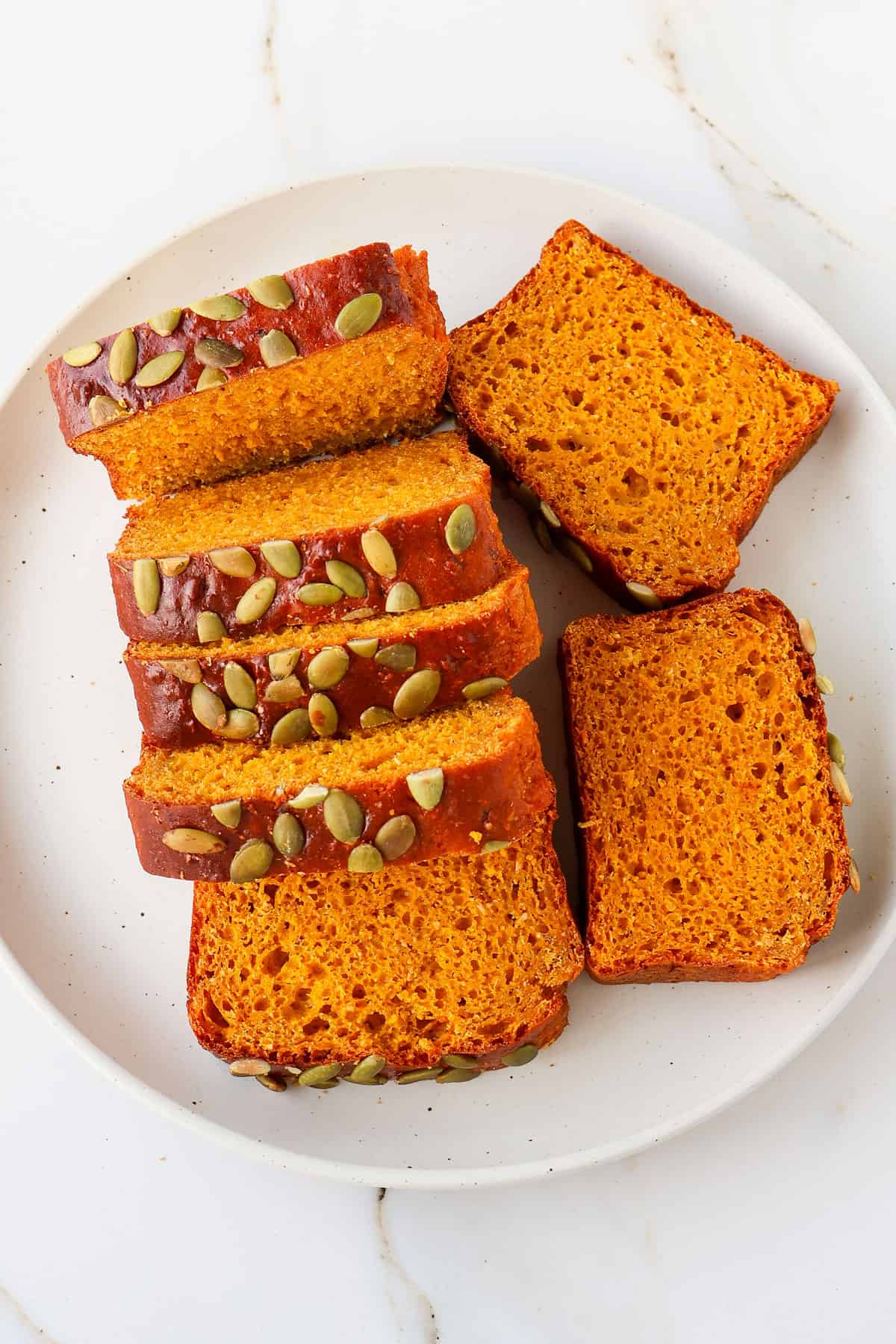 Sliced protein pumpkin bread on a plate.