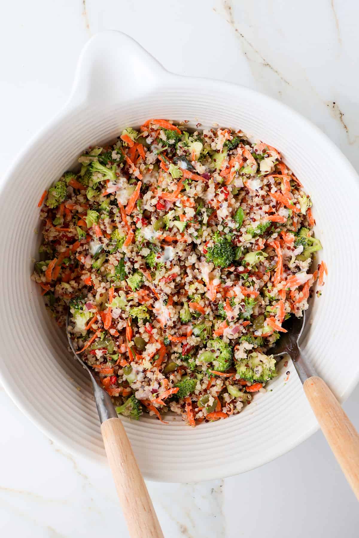 Broccoli quinoa salad in a mixing bowl.
