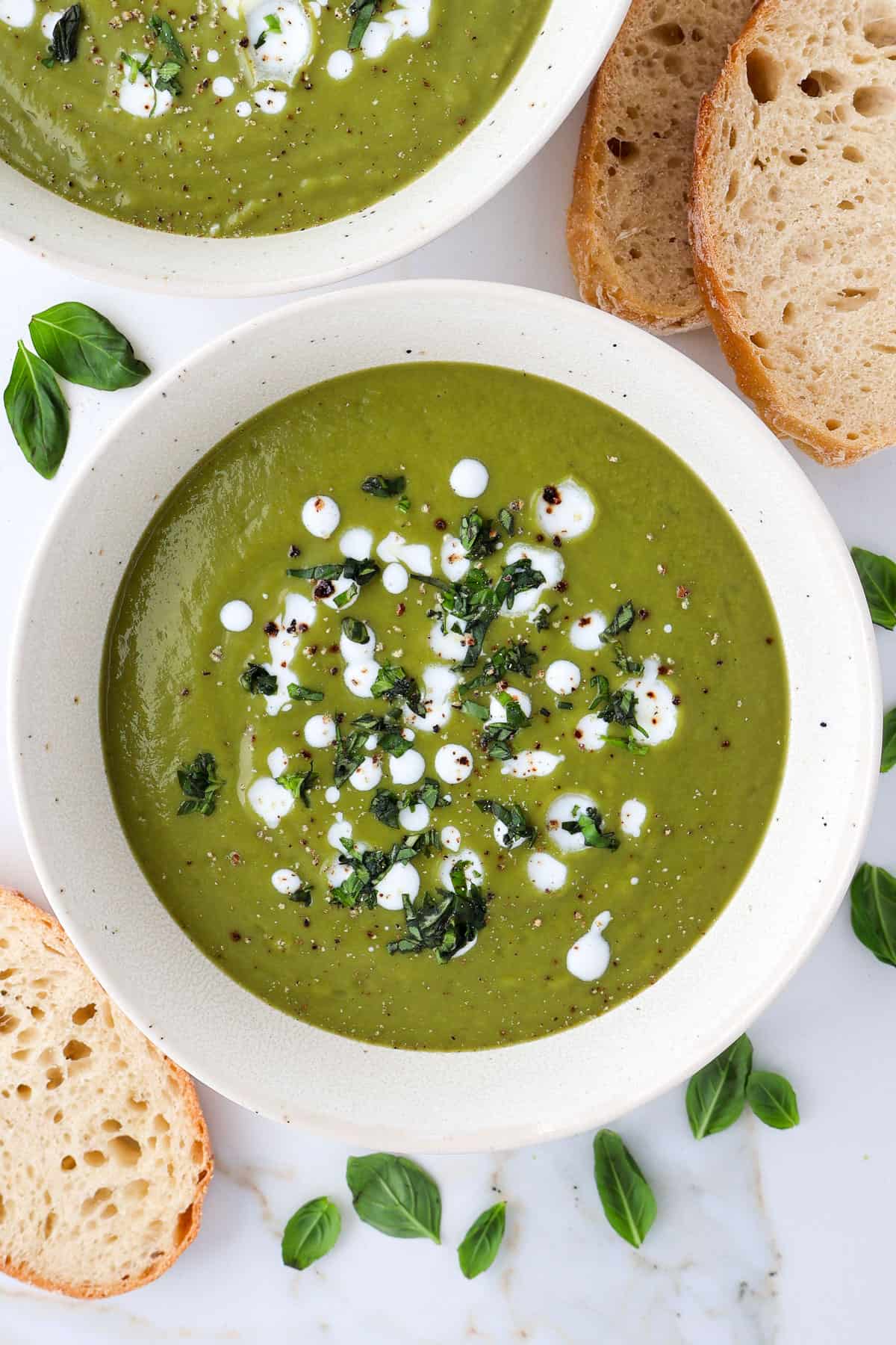 Broccoli pea soup in two bowls.