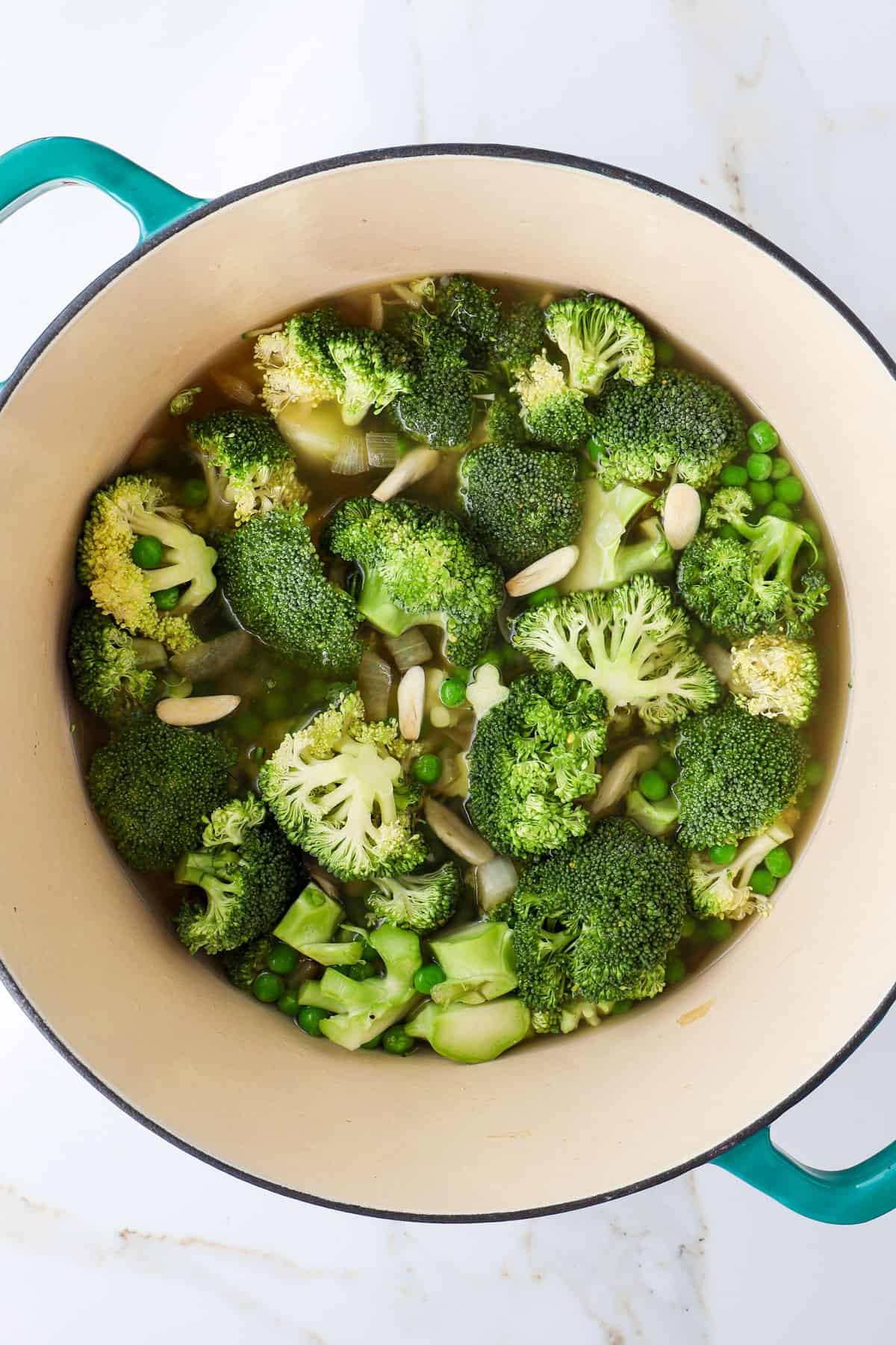Broccoli, garlic, onion and peas in a pot.
