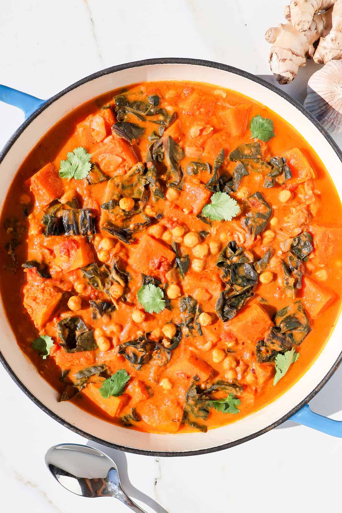 Butternut squash curry in a pot topped with coriander.