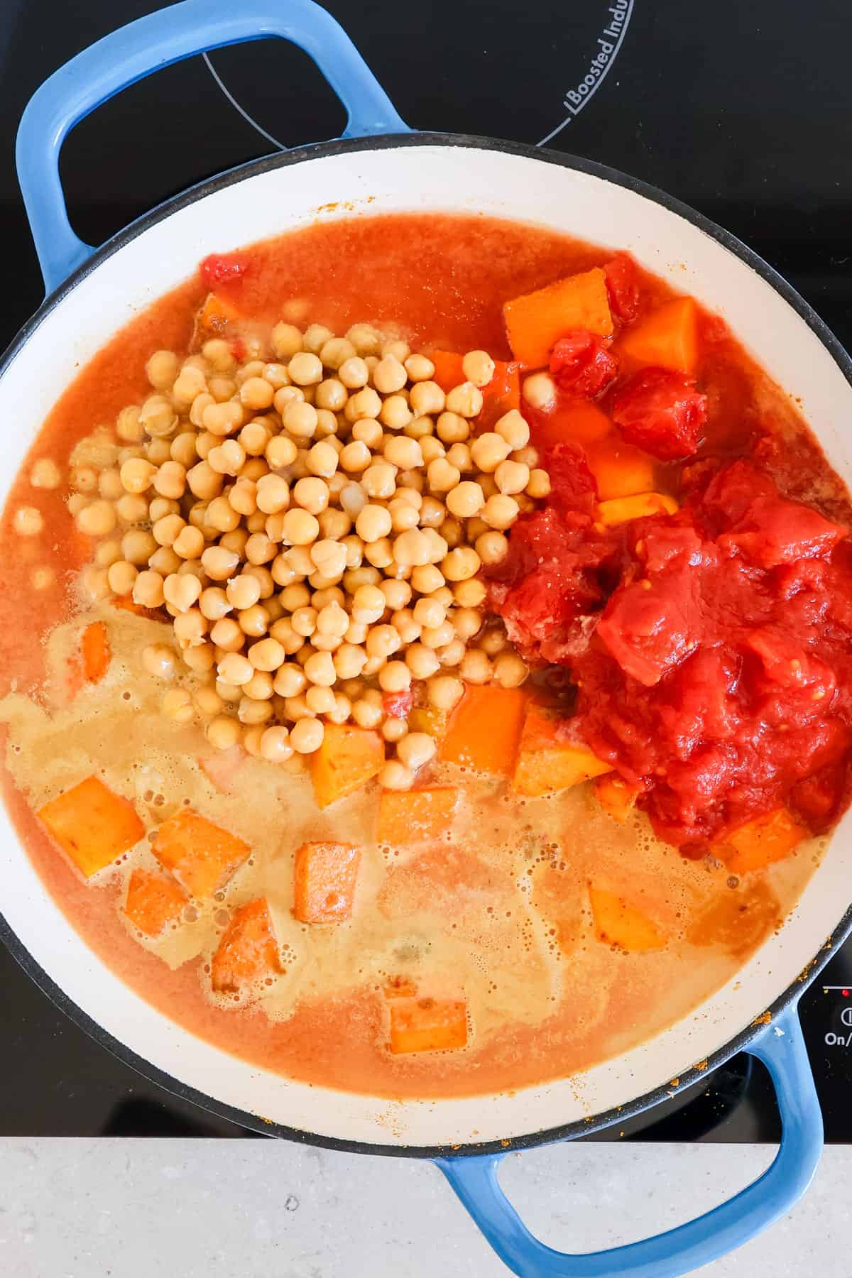 Tomatoes, chickpeas and peanut butter added to the pot.
