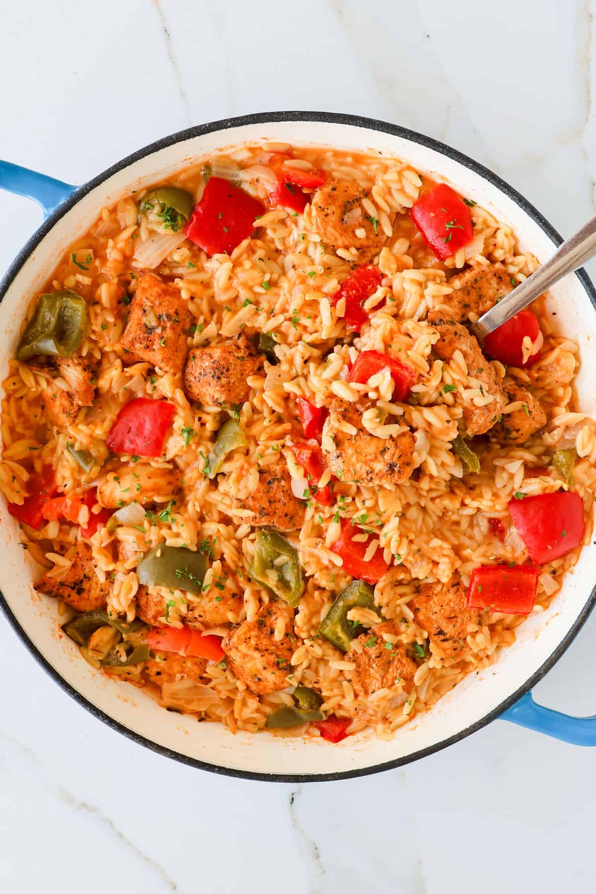 Chicken orzo with a spoon scooped in.