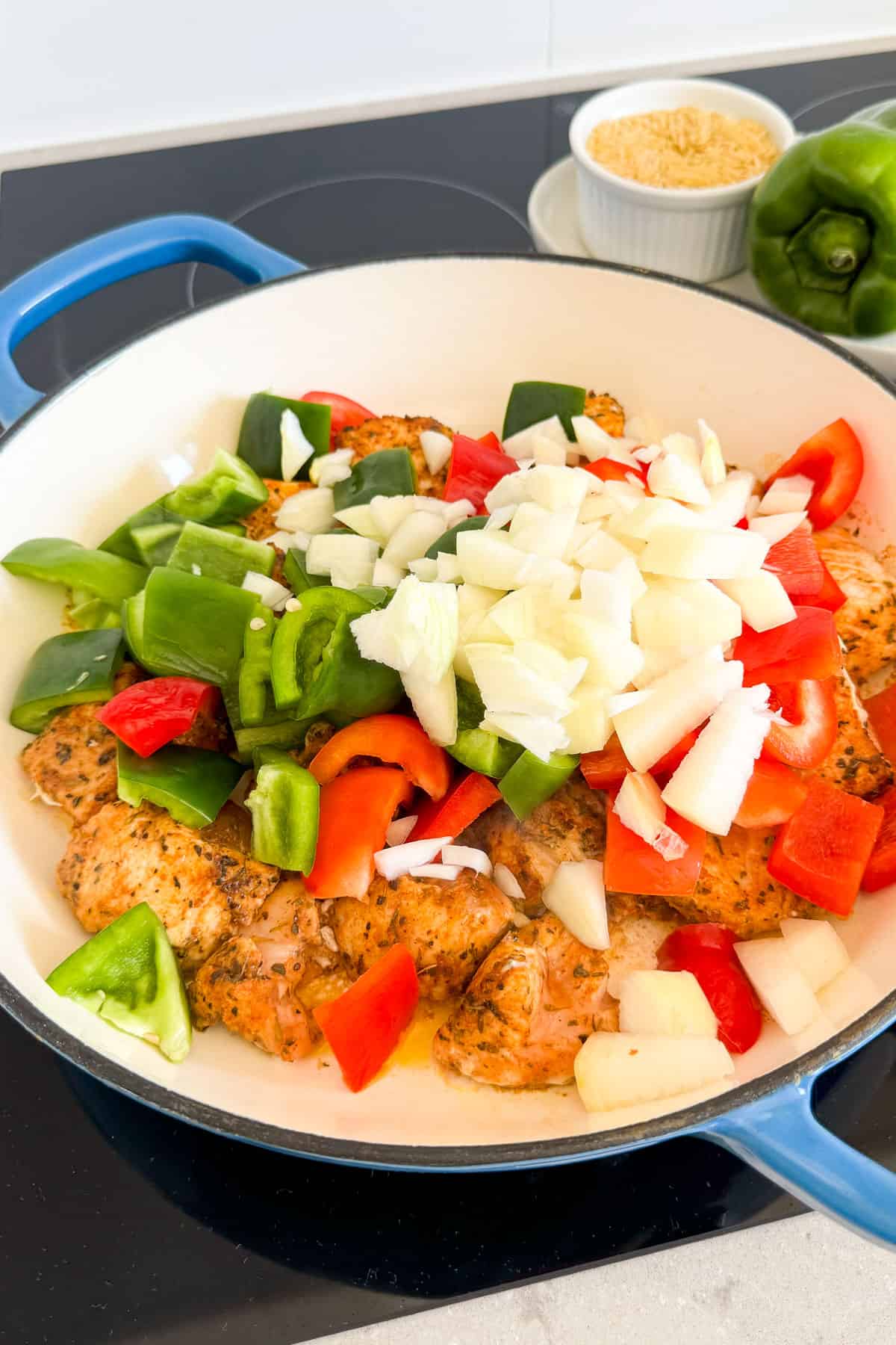 Chicken and veggies in a pan.