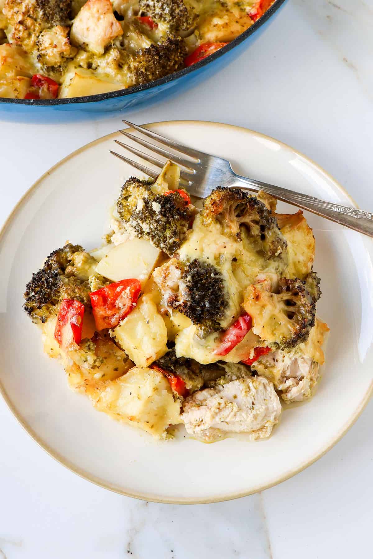 Side shot of the chicken casserole on a plate with a fork.