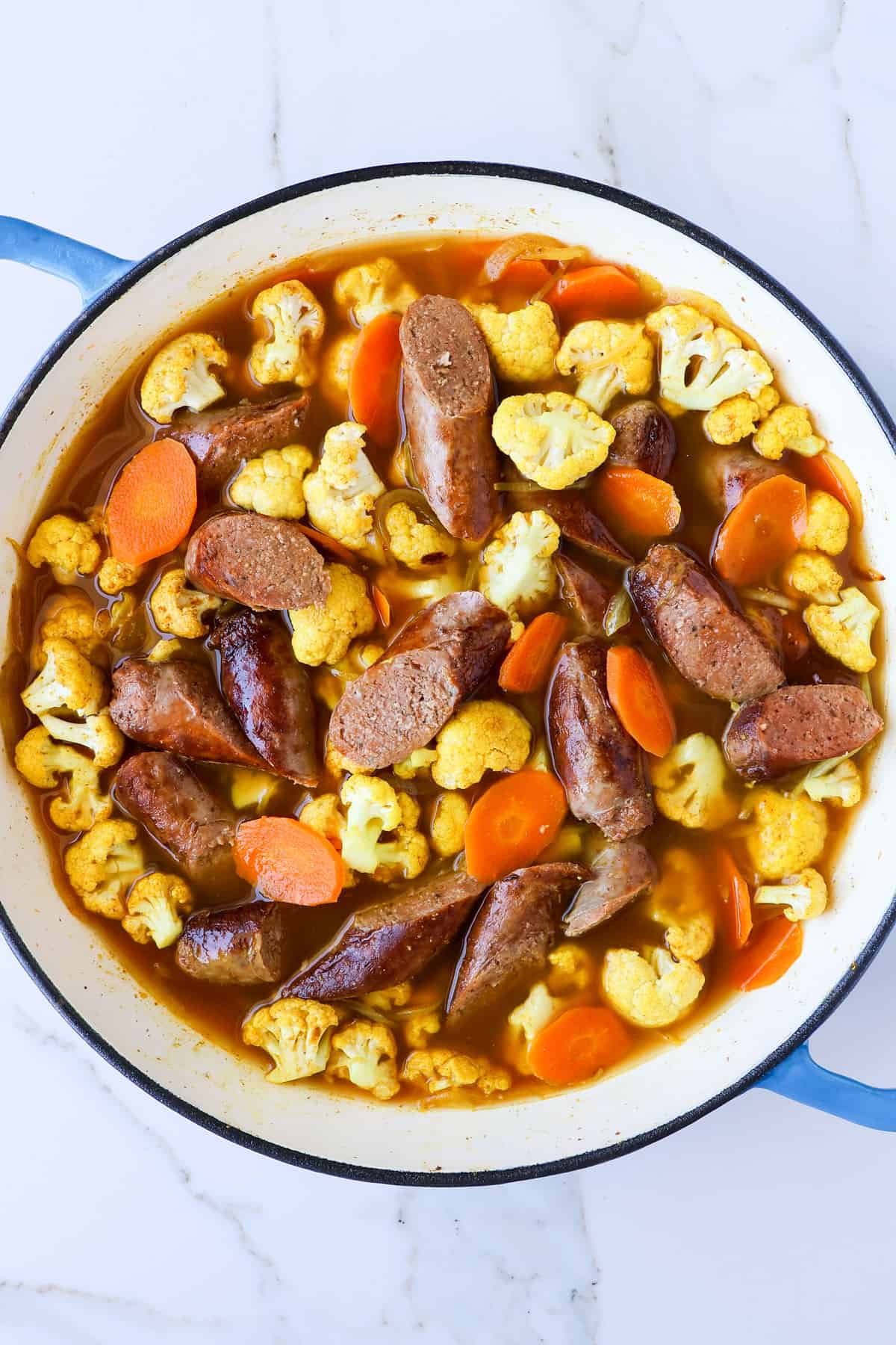 Cooked and sliced sausages added back to the pot.