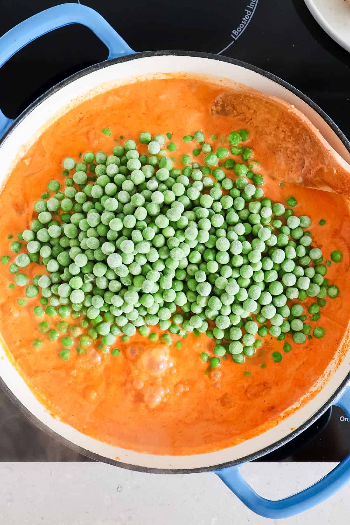 Frozen peas added to the pan.