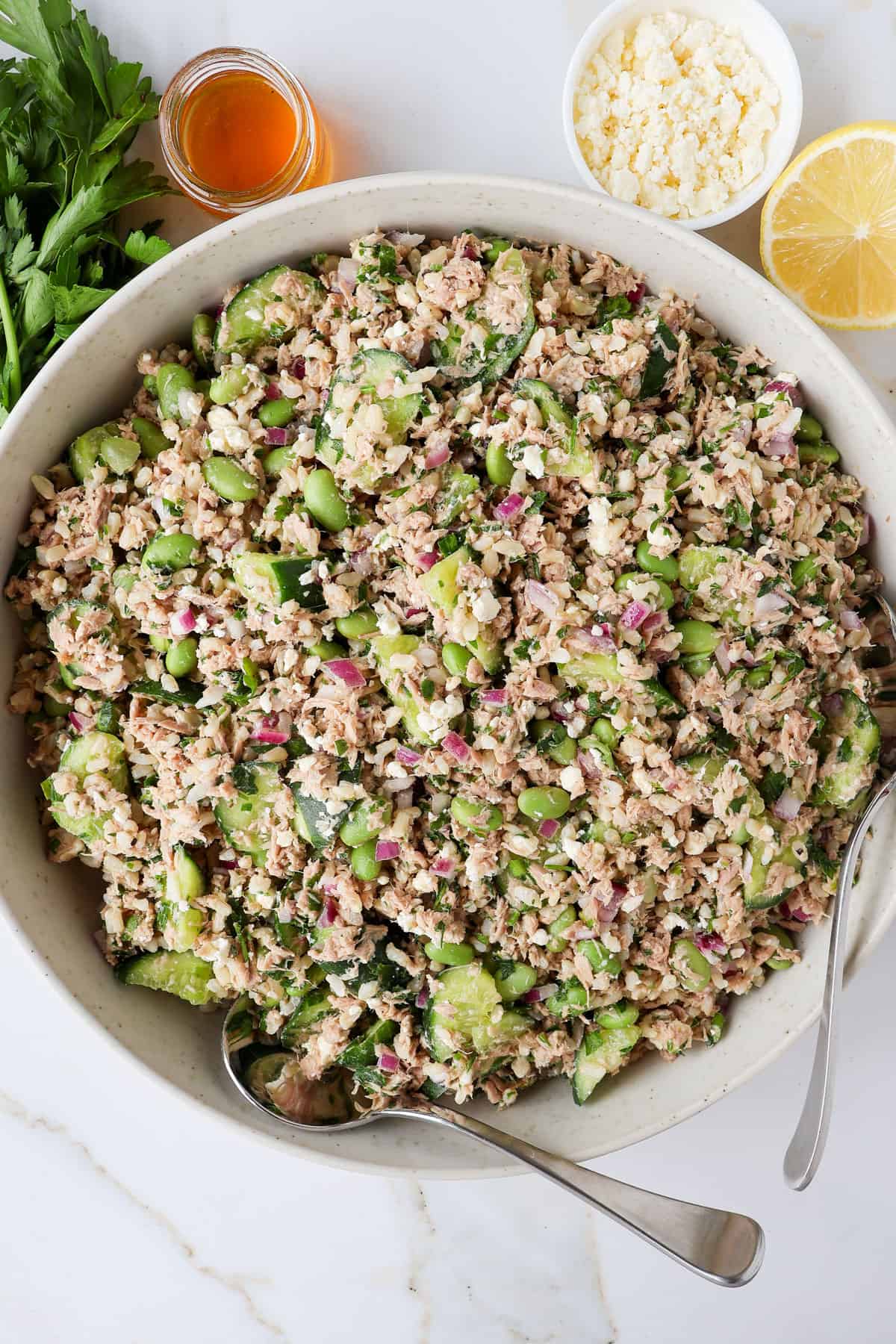 Tuna cucumber salad in a bowl with spoons.