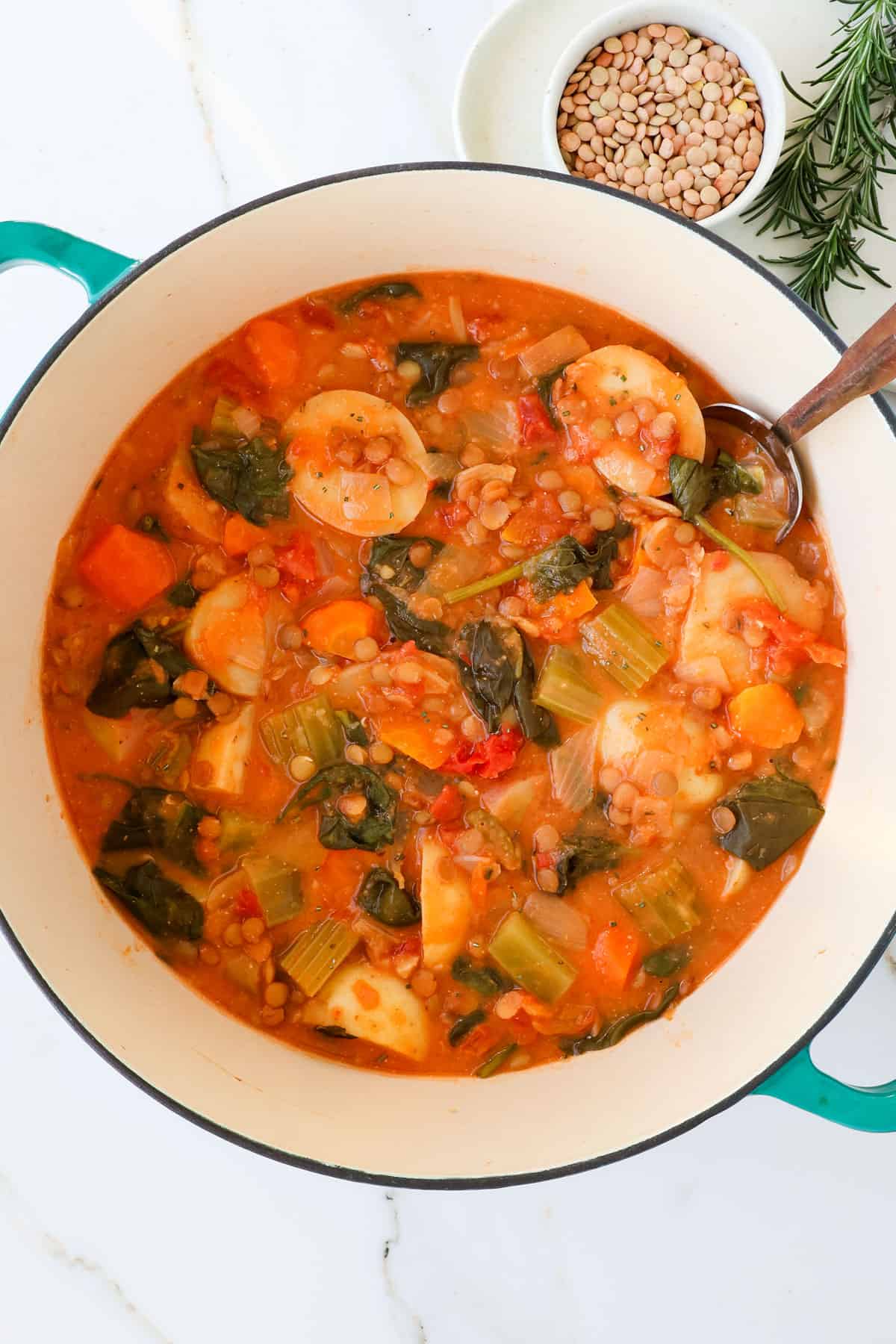 Potato stew in a pot with a spoon.