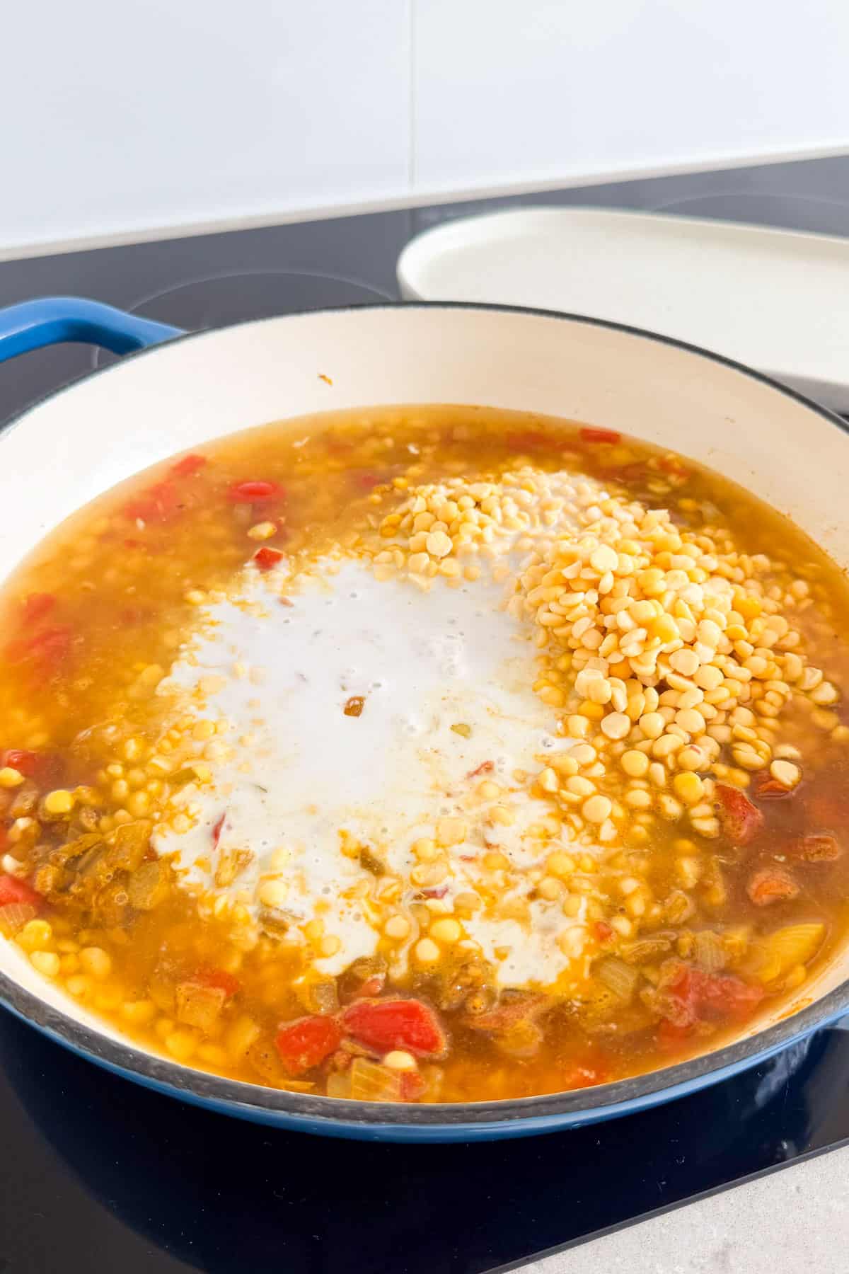 Coconut milk, stock and split peas added to the pot.