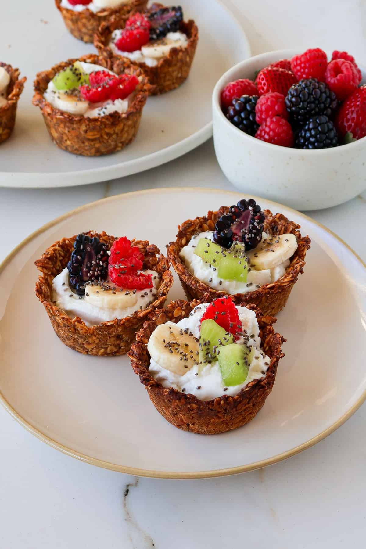 Side shot of 3 granola yogurt cups.