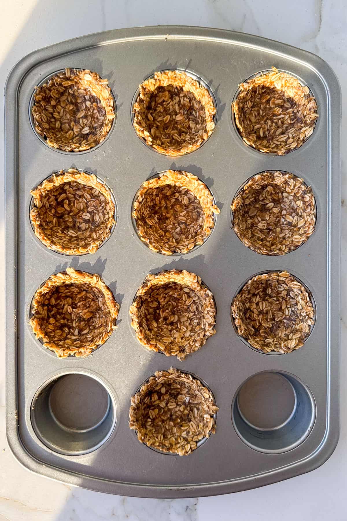 Raw mixture in muffin pan.